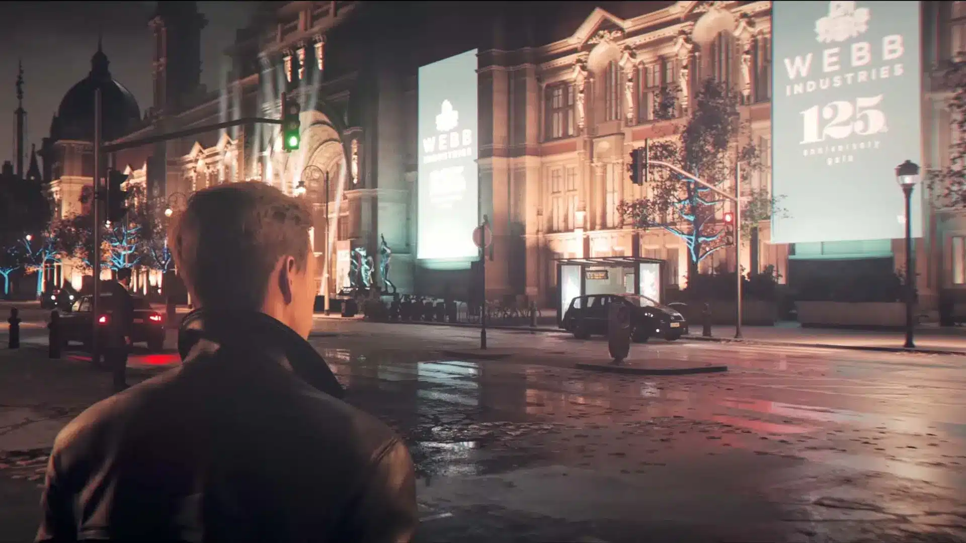 Over-the-shoulder view of a man in a leather jacket looking at a city street with Webb Industries billboards