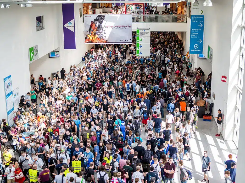 Crowd gathered in the exhibition hall at Gamescom in Cologne.