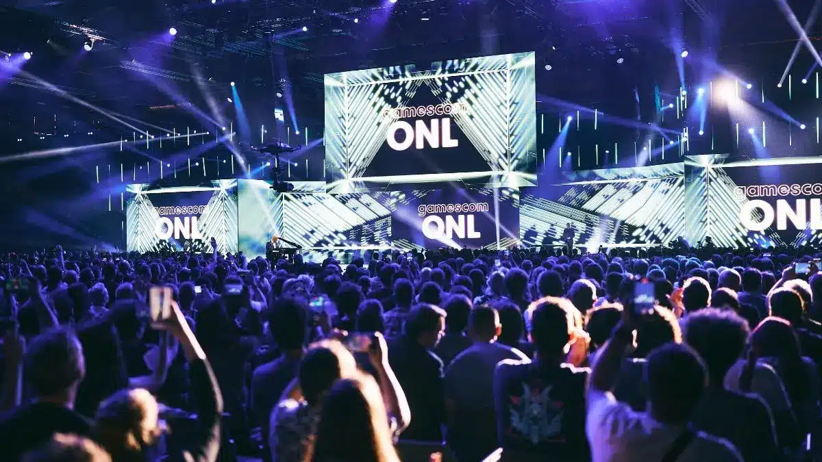 Crowd at Gamescom Opening Night Live stage with lit screens.