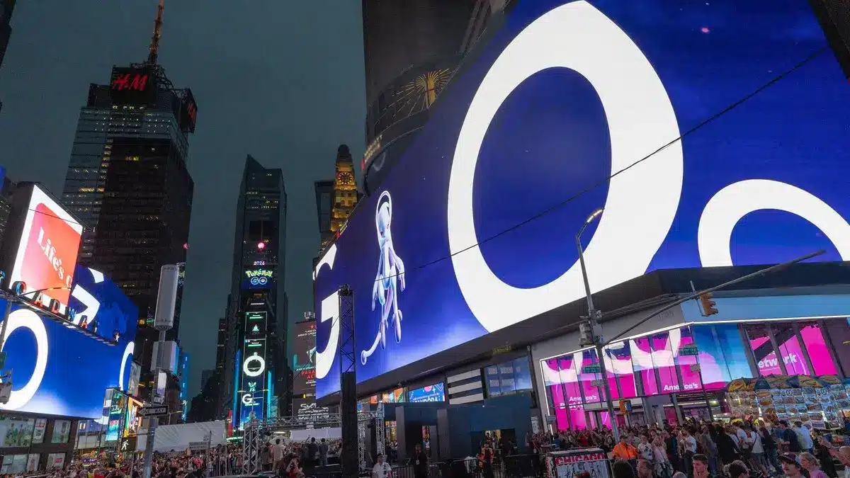 Bright advertisement featuring Mewtwo in Times Square for Pokemon GO event.