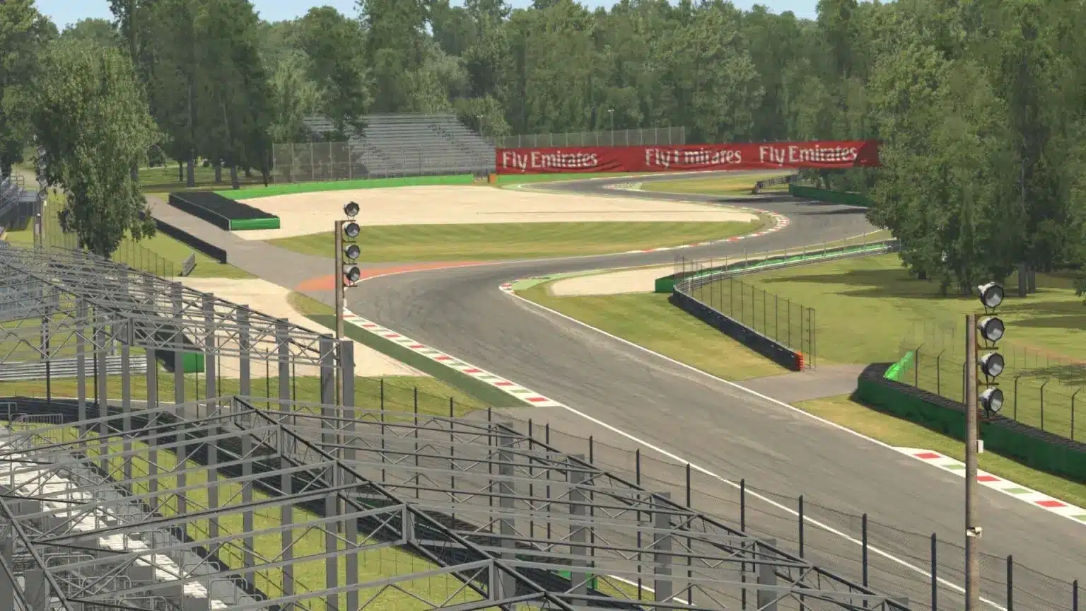 A high-angle view of the Monza circuit track in iRacing, showing a winding curve with red and white curbs.